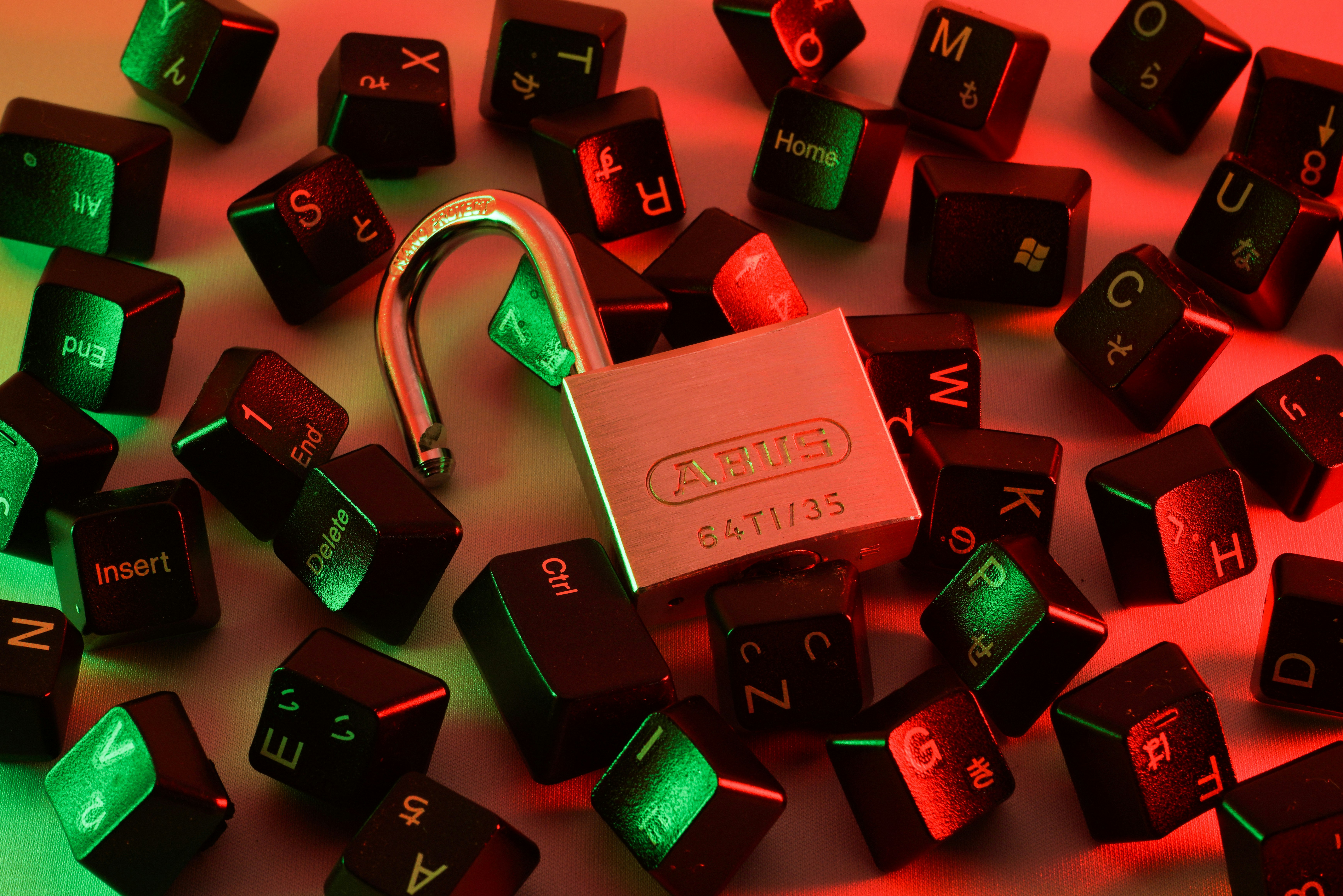 Padlock on scattered keyboard keys highlighting cybersecurity, representing best practices for securing Python applications in web development and data analysis.