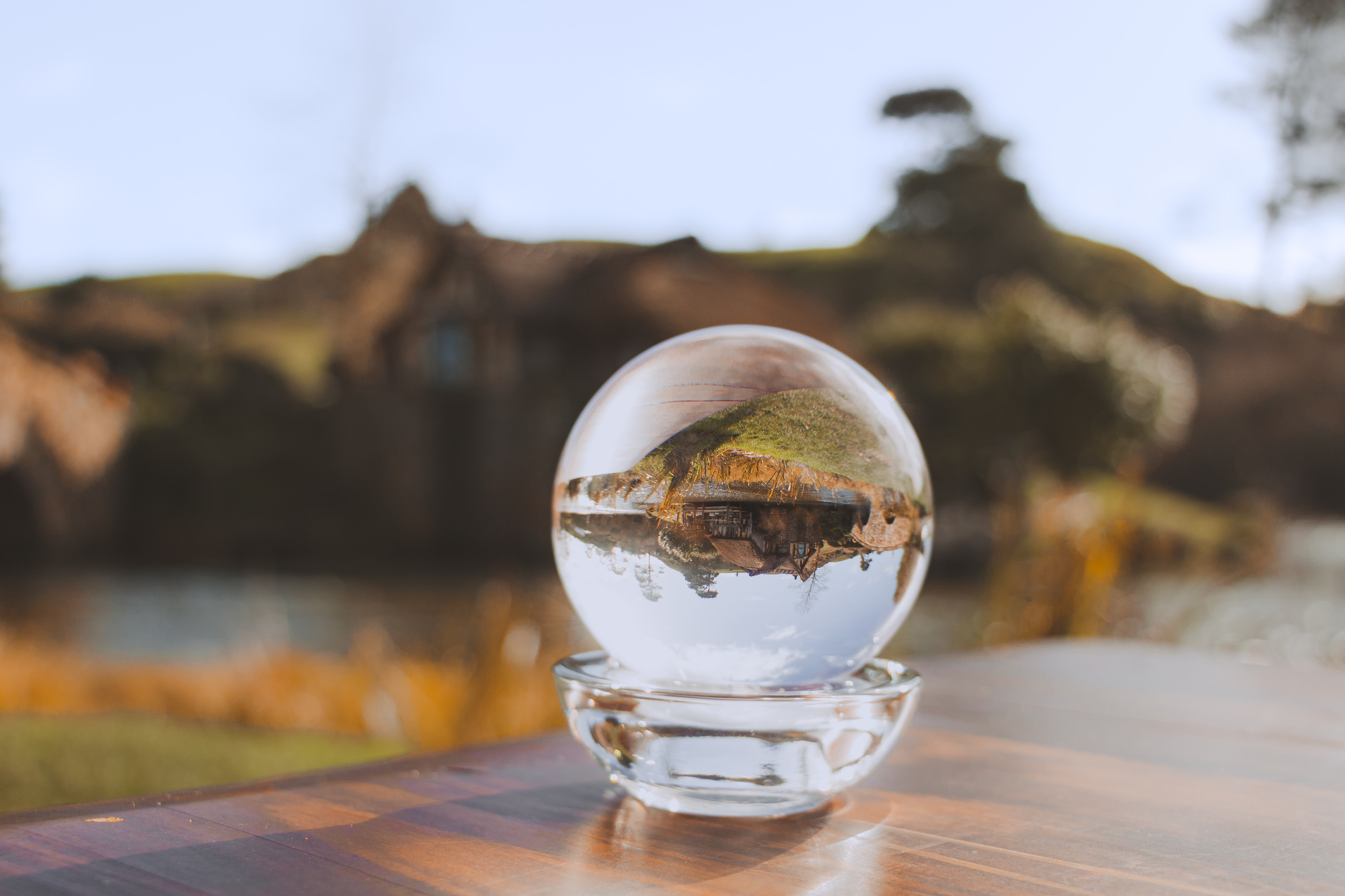 Crystal ball reflecting an inverted serene landscape, symbolizing the inversion of perspective offered by the dependency inversion principle.