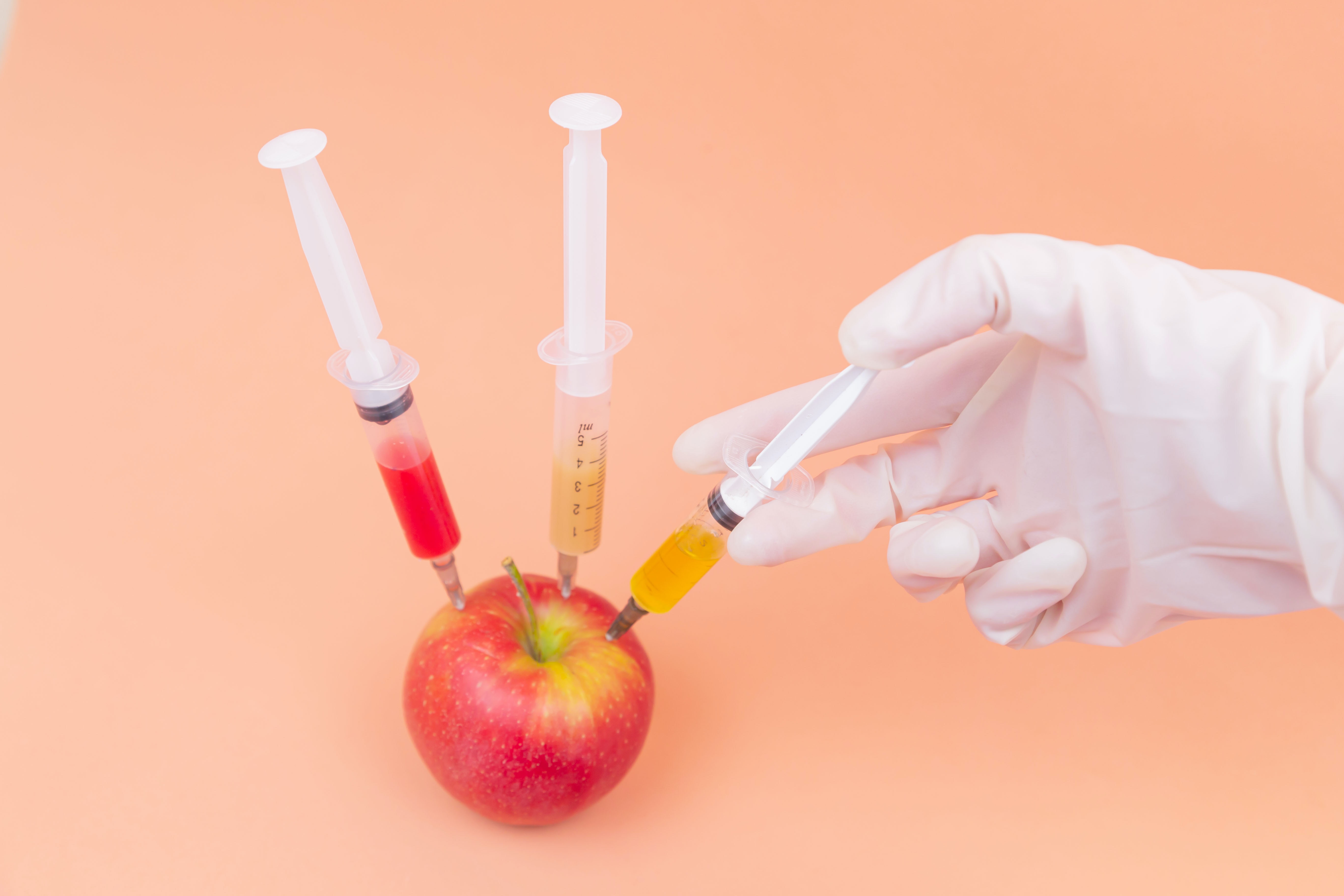 Apple being injected with syringes, depicting Python dependency injection best practices in a conceptual manner.