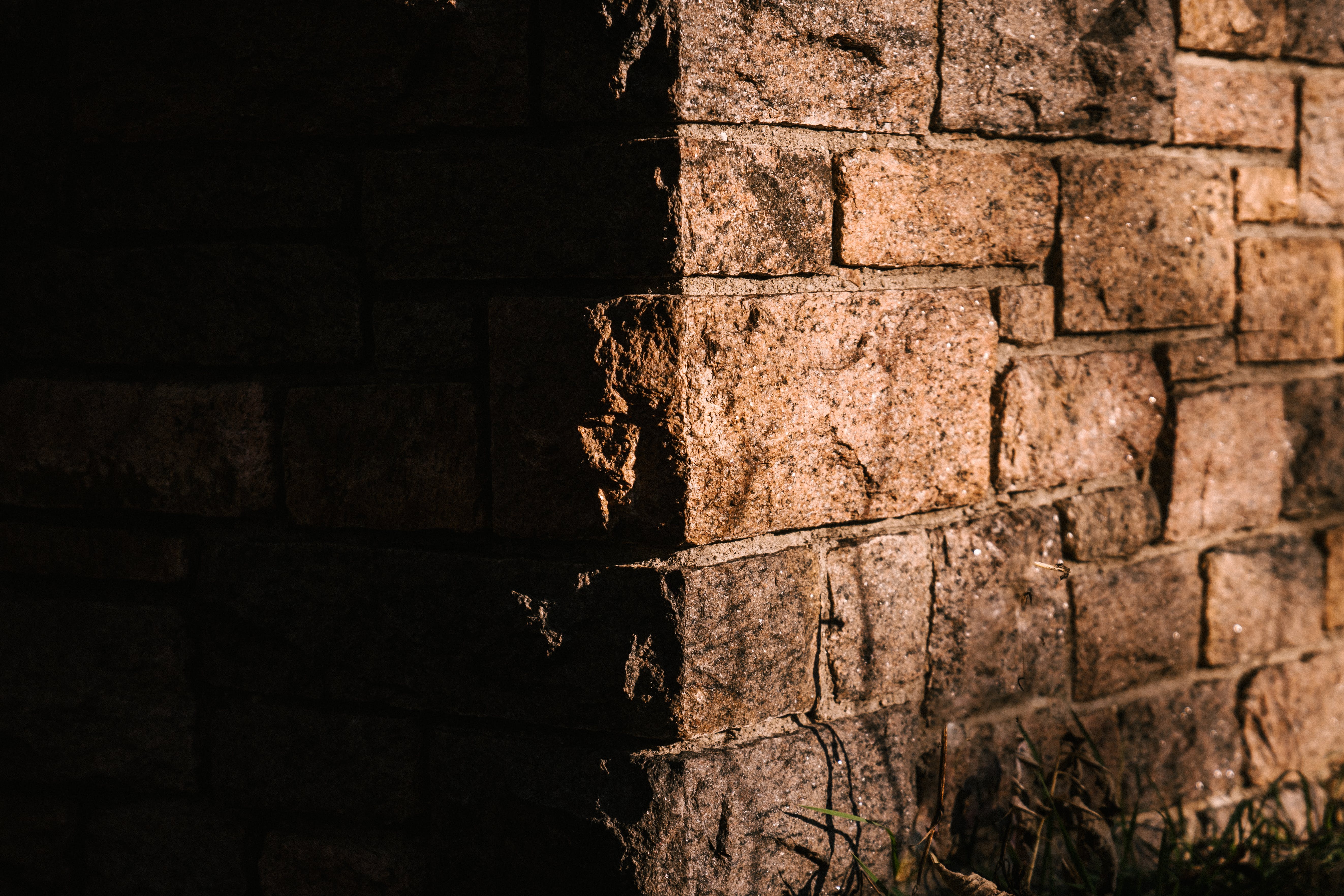 Photorealistic image showcasing the textured detail of a brick wall, symbolizing the application of SOLID principles in Python programming for building robust and maintainable code structures.